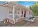 Inviting front porch with decorative elements, complemented by brick accents and a well-maintained exterior at 6106 Misty Valley Se Dr, Acworth, GA 30102