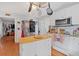 Bright kitchen features stainless steel appliances and an island with butcher block countertop at 6106 Misty Valley Se Dr, Acworth, GA 30102