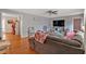 Cozy living room featuring hardwood floors, ceiling fan, and a comfortable gray sofa at 6106 Misty Valley Se Dr, Acworth, GA 30102