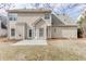 Back exterior with a patio and a well-maintained lawn in a residential neighborhood at 2341 Walnut Tree Ct, Buford, GA 30519