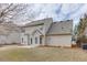 An exterior view of the rear of the home with siding and a small patio in the backyard at 2341 Walnut Tree Ct, Buford, GA 30519