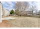 A view of the backyard with a small patio and a large grassy area at 2341 Walnut Tree Ct, Buford, GA 30519