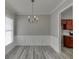 Dining room featuring hardwood floors, modern lighting, and wainscoting at 2341 Walnut Tree Ct, Buford, GA 30519