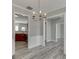 Charming dining room with gray vinyl floors and a stylish chandelier, blending classic elegance with modern design at 2341 Walnut Tree Ct, Buford, GA 30519