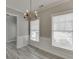 Dining room with natural light, a modern chandelier, and classic gray floors at 2341 Walnut Tree Ct, Buford, GA 30519