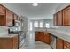 Modern kitchen featuring stainless steel appliances, granite countertops, and wooden cabinets at 2341 Walnut Tree Ct, Buford, GA 30519