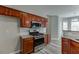 Modern kitchen featuring stainless steel appliances, granite countertops, and wooden cabinets at 2341 Walnut Tree Ct, Buford, GA 30519