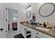 Bathroom with double sinks, neutral counters, and modern lighting fixtures at 79 Nimblewood Trl, Acworth, GA 30101