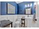 Stylish half bathroom with decorative art, a pedestal sink, and white wainscoting at 79 Nimblewood Trl, Acworth, GA 30101