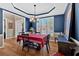 Elegant dining room with blue accent wall, a chandelier, and natural light at 79 Nimblewood Trl, Acworth, GA 30101