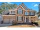 Charming two-story brick home featuring a two-car garage and welcoming front porch at 79 Nimblewood Trl, Acworth, GA 30101