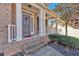 Inviting front porch with brick steps, white columns, and a charming entryway at 79 Nimblewood Trl, Acworth, GA 30101