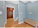 Hallway with wood floors, built-in cabinets, storage bench, and view of the staircase at 79 Nimblewood Trl, Acworth, GA 30101