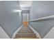 Carpeted stairs lead to the upper level, featuring a handrail and neutral wall color at 79 Nimblewood Trl, Acworth, GA 30101