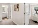 Upstairs hallway featuring art and views into a bathroom and seating area at 1340 Magnolia Bend Way # 288, Jonesboro, GA 30238