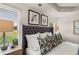 Bright bedroom showcasing a large upholstered headboard, with bedside tables and two windows at 1340 Magnolia Bend Way, Jonesboro, GA 30238