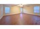 Spacious bedroom with three windows and hardwood floors at 2098 Cutleaf Creek Rd, Grayson, GA 30017