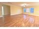Open-concept living room featuring hardwood floors and abundant natural light from the windows at 2098 Cutleaf Creek Rd, Grayson, GA 30017