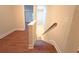 Staircase with wooden steps and white railing leading to the lower level at 2098 Cutleaf Creek Rd, Grayson, GA 30017