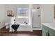 Bright bathroom featuring a tub, shower, stylish vanity, and elegant wood-look flooring at 2121 Lindley Nw Ln, Kennesaw, GA 30144