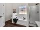 Bright bathroom with a soaking tub, glass-enclosed shower, and modern fixtures at 2121 Lindley Nw Ln, Kennesaw, GA 30144