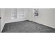 Bright bedroom with gray carpet, large window, and white built-in shelving at 2121 Lindley Nw Ln, Kennesaw, GA 30144