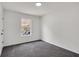 This cozy bedroom has gray carpet, white walls and a large window allowing for natural light at 2121 Lindley Nw Ln, Kennesaw, GA 30144