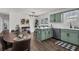 Well-appointed kitchen featuring green cabinetry, stainless steel appliances, and a cozy breakfast nook at 2121 Lindley Nw Ln, Kennesaw, GA 30144