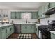 Kitchen featuring green cabinetry, stainless steel appliances, and a breakfast bar at 2121 Lindley Nw Ln, Kennesaw, GA 30144