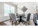 Stylish dining room with a round table, modern chandelier, and decorative wall art at 123 Maplewood Ln, Conyers, GA 30094