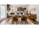 Kitchen and dining area with dark wood cabinets, granite countertops and dining table with seating for six at 123 Maplewood Ln, Conyers, GA 30094