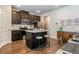 Kitchen with a large island, stainless appliances, dark wood cabinets, and hardwood flooring at 123 Maplewood Ln, Conyers, GA 30094