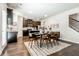 Eat-in kitchen and dining area with stylish wood table and view to kitchen with dark cabinets at 123 Maplewood Ln, Conyers, GA 30094