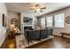 Comfortable living room featuring a fireplace, ceiling fan, and plenty of natural light at 123 Maplewood Ln, Conyers, GA 30094