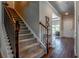 Carpeted staircase featuring stained wood banister and view of the foyer and entry way at 123 Maplewood Ln, Conyers, GA 30094