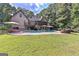 Expansive backyard featuring a pool, patio, and lush green lawn at 1230 Mars Hill Nw Rd, Acworth, GA 30101