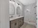Beautiful bathroom featuring a double vanity with marble counters and a frameless glass shower with stone flooring at 133 Old Alabama Se Rd, Emerson, GA 30137