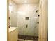 Modern bathroom featuring marble-tiled walk-in shower with black hardware and vanity at 133 Old Alabama Se Rd, Emerson, GA 30137