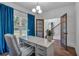 Bright home office with large window, white desk, stylish decor, and adjacent staircase access at 133 Old Alabama Se Rd, Emerson, GA 30137