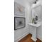 Stylish powder room with pedestal sink, modern mirror, and artistic wall decorations at 133 Old Alabama Se Rd, Emerson, GA 30137