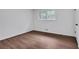 A simple bedroom with hardwood floors is illuminated with a window bringing natural light at 3046 Wendgate Dr, Marietta, GA 30062