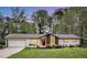 Charming one-story home with a two-car garage, a red door, and a manicured lawn at 3046 Wendgate Dr, Marietta, GA 30062