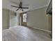 Spacious bedroom featuring light-colored walls, wood-look floors, and a ceiling fan at 1010 Martin Ln, Canton, GA 30114