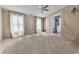 Bedroom featuring a ceiling fan, neutral walls, and a view of the outdoors through the window at 1010 Martin Ln, Canton, GA 30114