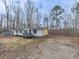 Exterior view of the house and lot surrounded by mature trees at 1010 Martin Ln, Canton, GA 30114