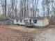 Exterior view of the house and lot surrounded by mature trees at 1010 Martin Ln, Canton, GA 30114