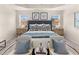 A beautifully staged main bedroom with a tufted headboard, stylish furniture, and elegant decor at 1338 Magnolia Bend Way # 289, Jonesboro, GA 30238