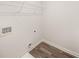 Unfinished storage space boasts new vinyl flooring, white walls, wire shelves, and utility connections at 1338 Magnolia Bend Way # 289, Jonesboro, GA 30238