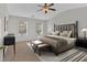 Spacious main bedroom with a ceiling fan, large windows, and neutral decor at 1795 Waterside Nw Dr # 7, Kennesaw, GA 30152