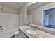 Bathroom featuring a shower-tub combo, large granite countertop, and neutral walls at 1797 Old Dogwood, Jonesboro, GA 30238